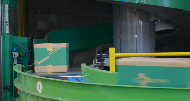 boxes under the intelligence scanner on a conveyor system