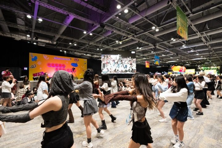 Photo of a group of fans dancing to a K-pop song.
