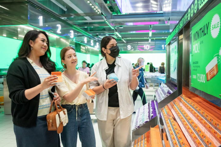 Tourists browse the curated range of products at CJ Olive Young’s “Monthly Pick” corner