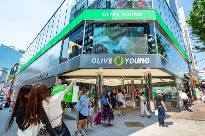 Tourists taking selfies in front of CJ Olive Young Myeongdong Town Store