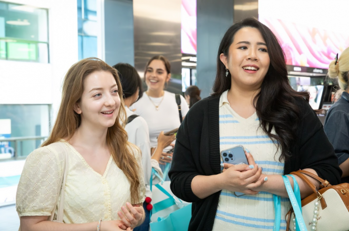 Visitors discuss their favorite K-beauty products at the CJ Olive Young Myeongdong Town Store