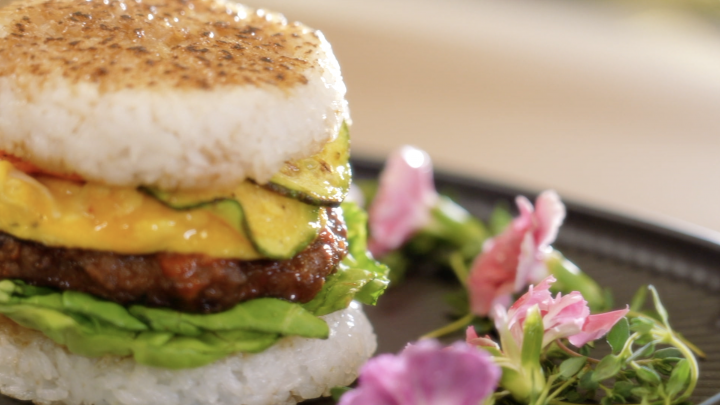 A tteokgalbi rice burger, with a cheesy vegetable gratin, an egg patty and glazed rice buns