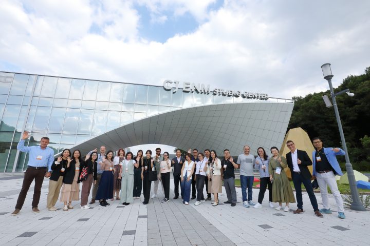 Group photo tour participants in front of CJ ENM Studio Center
