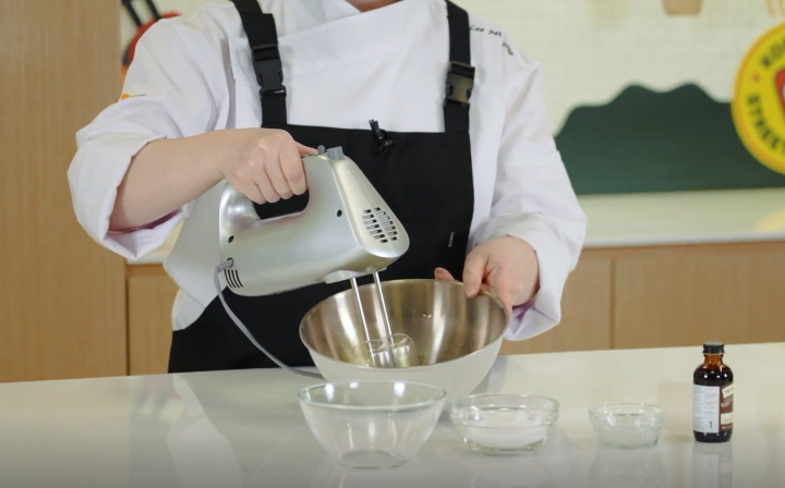 Chef whisking egg whites for a meringue. 
