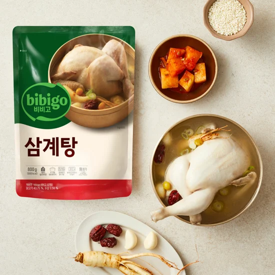 bibigo Ginseng Chicken Soup next to Kimchi, rice, chicken, and Ginseng ingredients