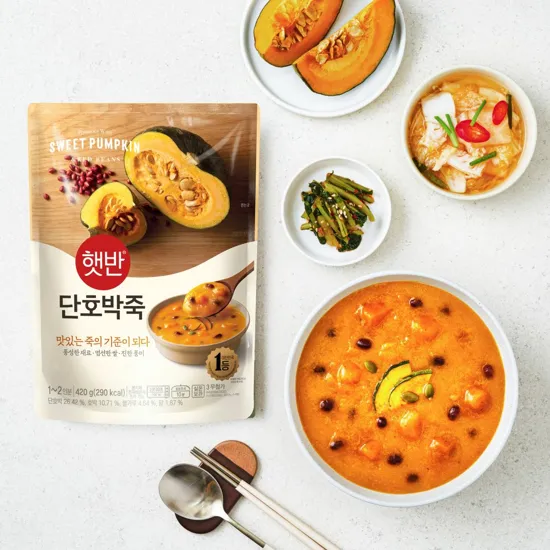 bibigo Sweet Pumpkin Porridge next to rice and Kimchi side dishes