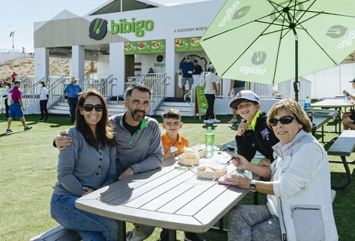 A family eating bibigo mandu lunch box at the bibigo concession set up at THE CJ CUP

