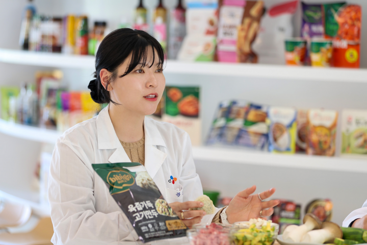 bibigo design team holding up a bibigo mandu