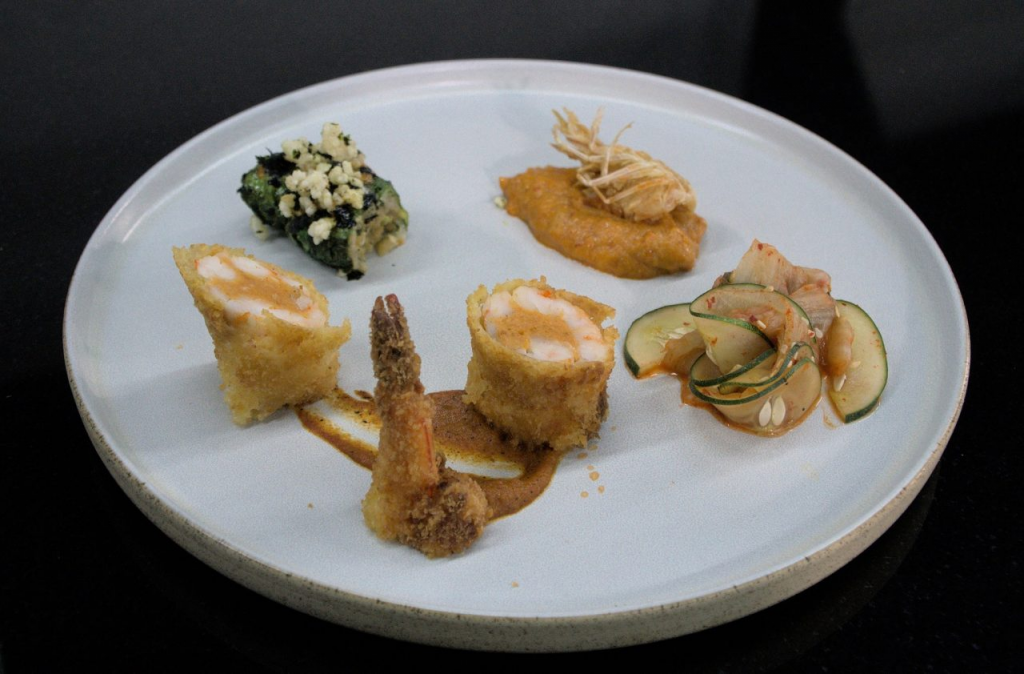 Chef Michael Khen Samuel’s winning dish, featuring dumplings, shrimp and cucumber kimchi on a white plate.