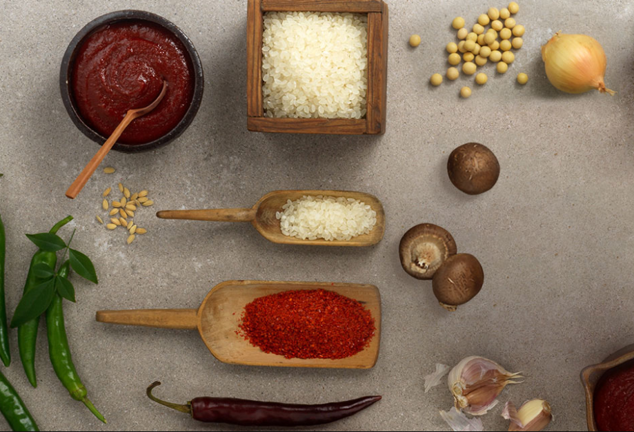 Traditional Korean ingredients used to make spicy flavors spread out on a grey stone table