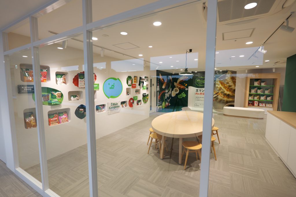 A view through a window of a room displaying several bibigo products.