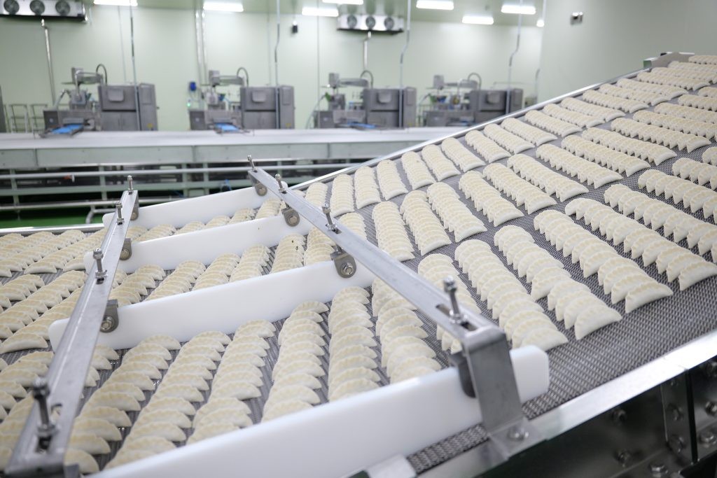 Lines of bibigo Mandu move down factory machines.