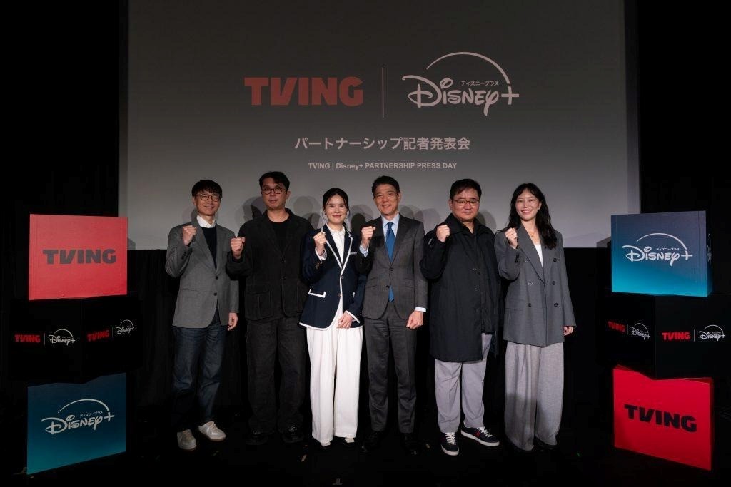 Representatives from TVING and Disney+ pose at a promotional event for their partnership. 
