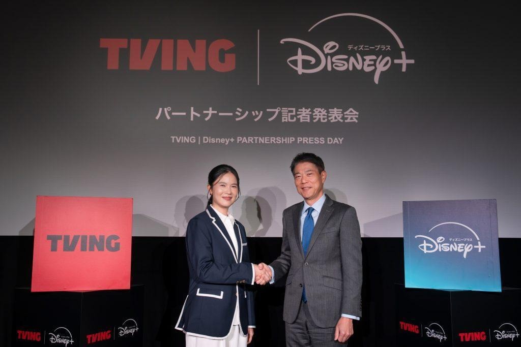 TVING CEO Julie Choi shakes hands with Walt Disney Company Japan President Tamotsu Hiiro.