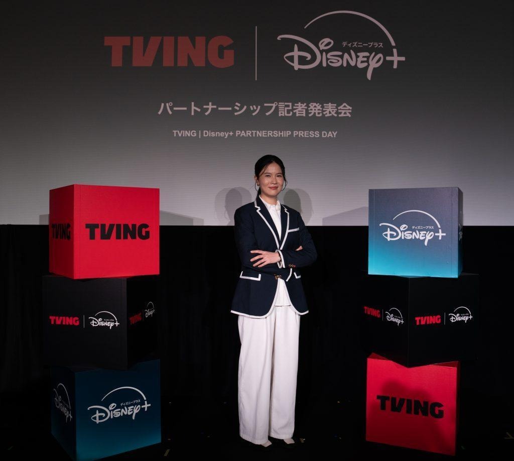 TVING CEO Julie Choi stands with crossed arms at a promotional event for TVING and Disney+.
