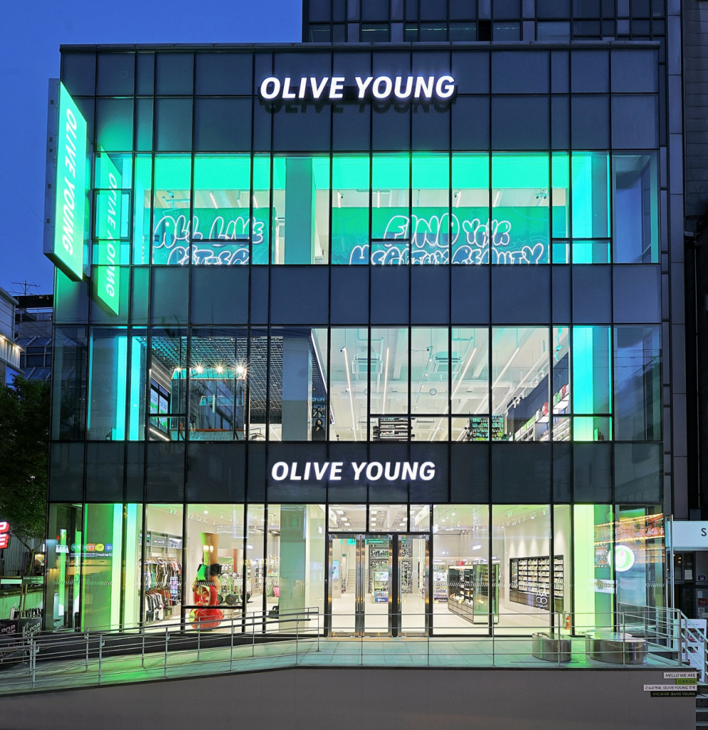 Exterior view of CJ Olive Young’s Hongdae Playground, a three-story building with large glass panes