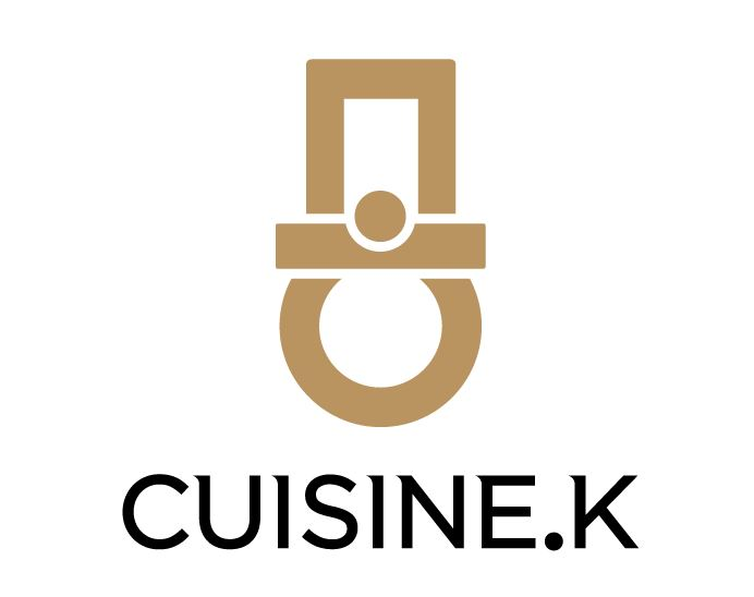 The Cuisine.K logo, a gold icon of a chef’s hat, below which is written “CUISINE.K” in black.
