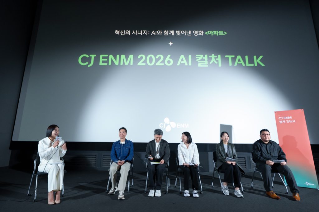 Panelists sit onstage during CJ ENM 2026 AI CULTURE TALK, with the event title displayed on a large screen behind them.