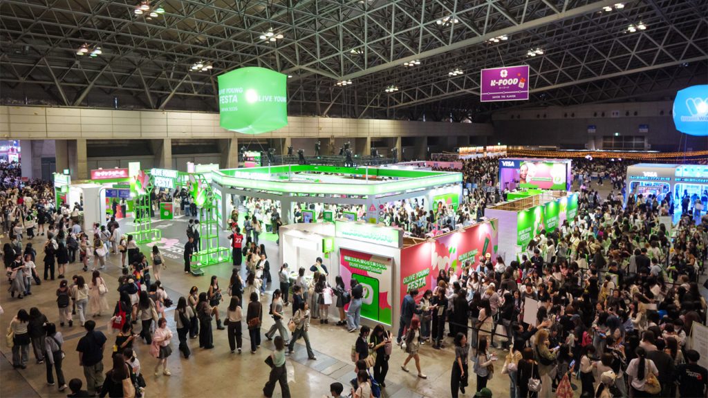 Visitors explore the OLIVE YOUNG FESTA booth and other K-lifestyle zones at KCON JAPAN 2026 in Makuhari Messe.