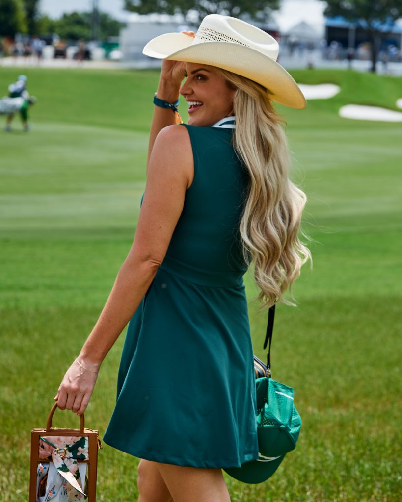 A stylish visitor posing in front of the golf course at THE CJ CUP Byron Nelson.