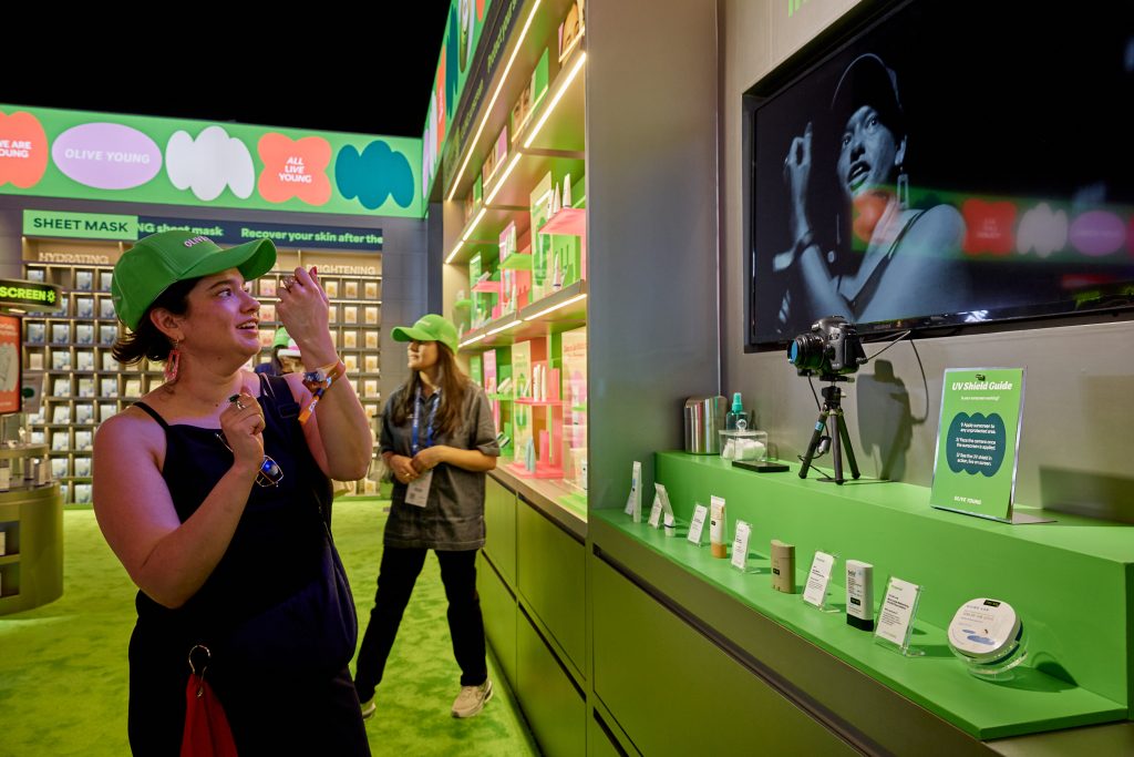 A visitor browses OLIVE YOUNG products at THE CJ CUP.