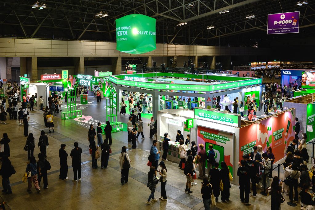 Wide view of the OLIVE YOUNG FESTA JAPAN 2026 booth at Makuhari Messe, with visitors exploring K-beauty zones and brand experiences.