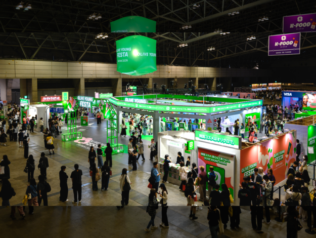 Wide view of the OLIVE YOUNG FESTA JAPAN 2026 booth at Makuhari Messe, with visitors exploring K-beauty zones and brand experiences.
