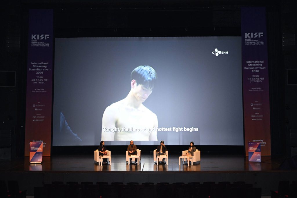 Panelists discuss K-content’s global growth during the 2026 International Streaming Summit, with footage from tvN’s “I Am Boxer” displayed on screen.