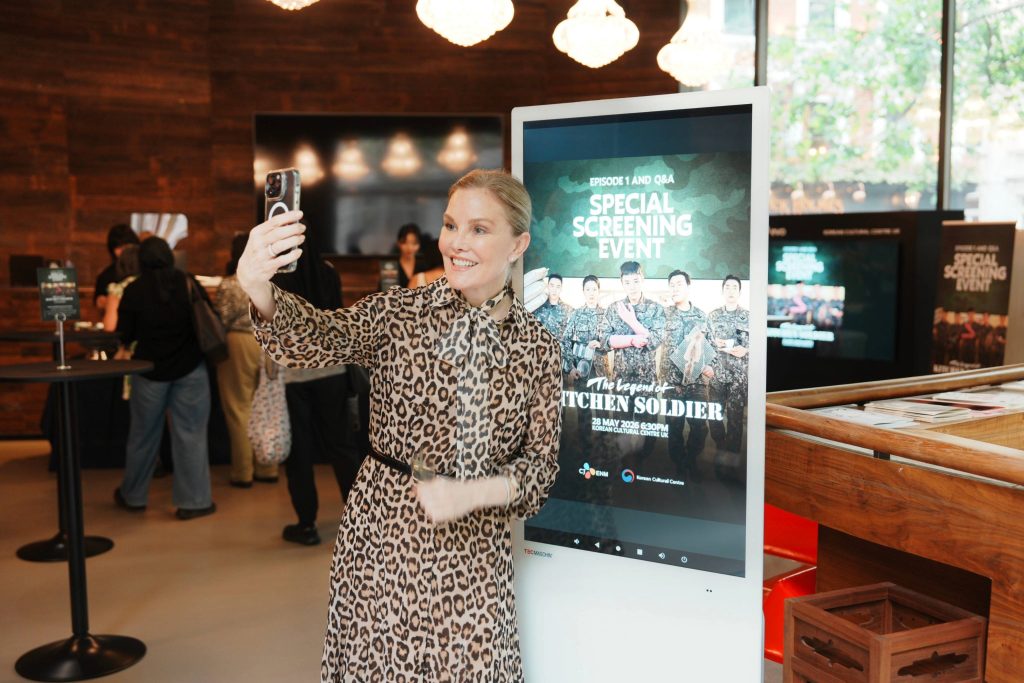 A guest takes a photo at CJ ENM’s exclusive London screening of “The Legend of Kitchen Soldier.”