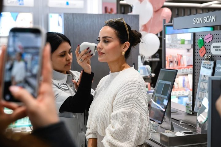 A customer uses the Skin Scan device to analyze her skin at OLIVE YOUNG’s first U.S. store.