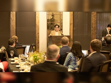 CJ Group Chairman Lee Jay-hyun speaks at a podium to a room filled with people.