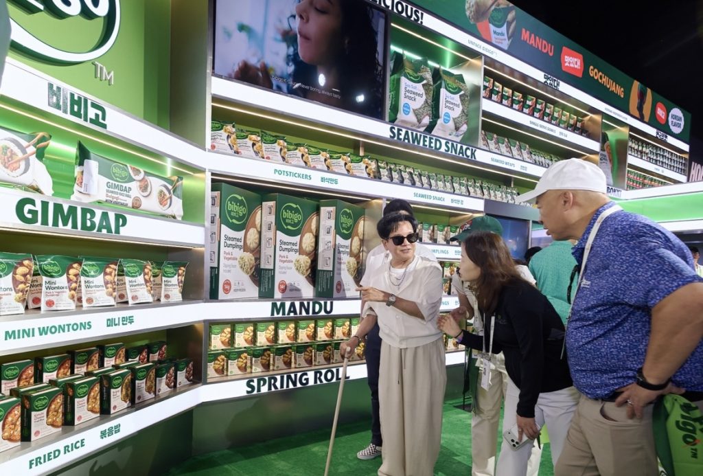 CJ Group Chairman Lee Jay-hyun receives a briefing at the bibigo booth inside House of CJ at THE CJ CUP Byron Nelson.
