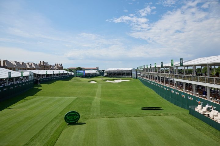 Wide view of THE CJ CUP course under a blue sky with a bibigo sign on the grass.