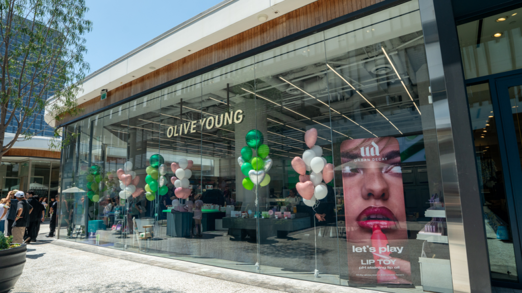 Exterior of OLIVE YOUNG Century City at Westfield Century City in Los Angeles, with balloons and beauty displays visible through the glass storefront.