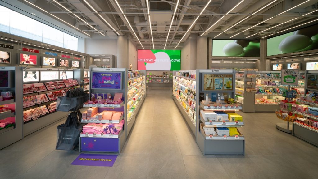 Interior of OLIVE YOUNG Century City, showing curated K-beauty shelves, O.Y Picks displays and product zones for makeup, skincare and wellness.