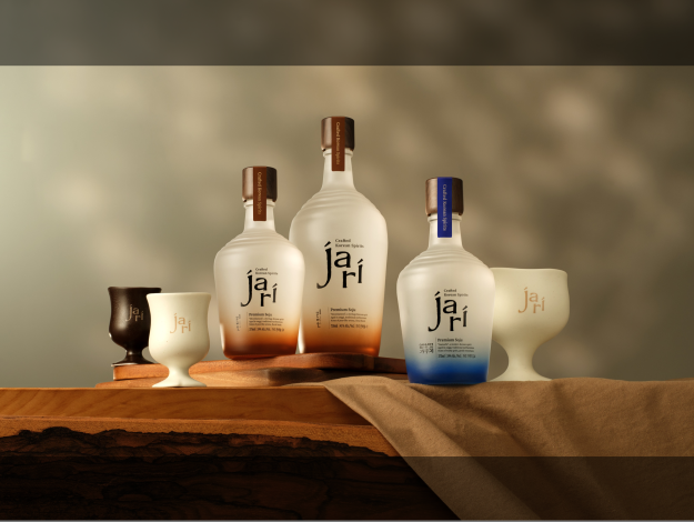 Two jari Premium Soju bottles with blue and amber accents displayed among dark ceramic spirit bottles
