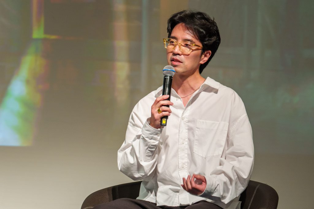 Director Lee Jang-hoon speaks into a microphone during the creator talk session.