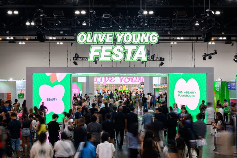 A wide shot of OLIVE YOUNG FESTA, packed with visitors.